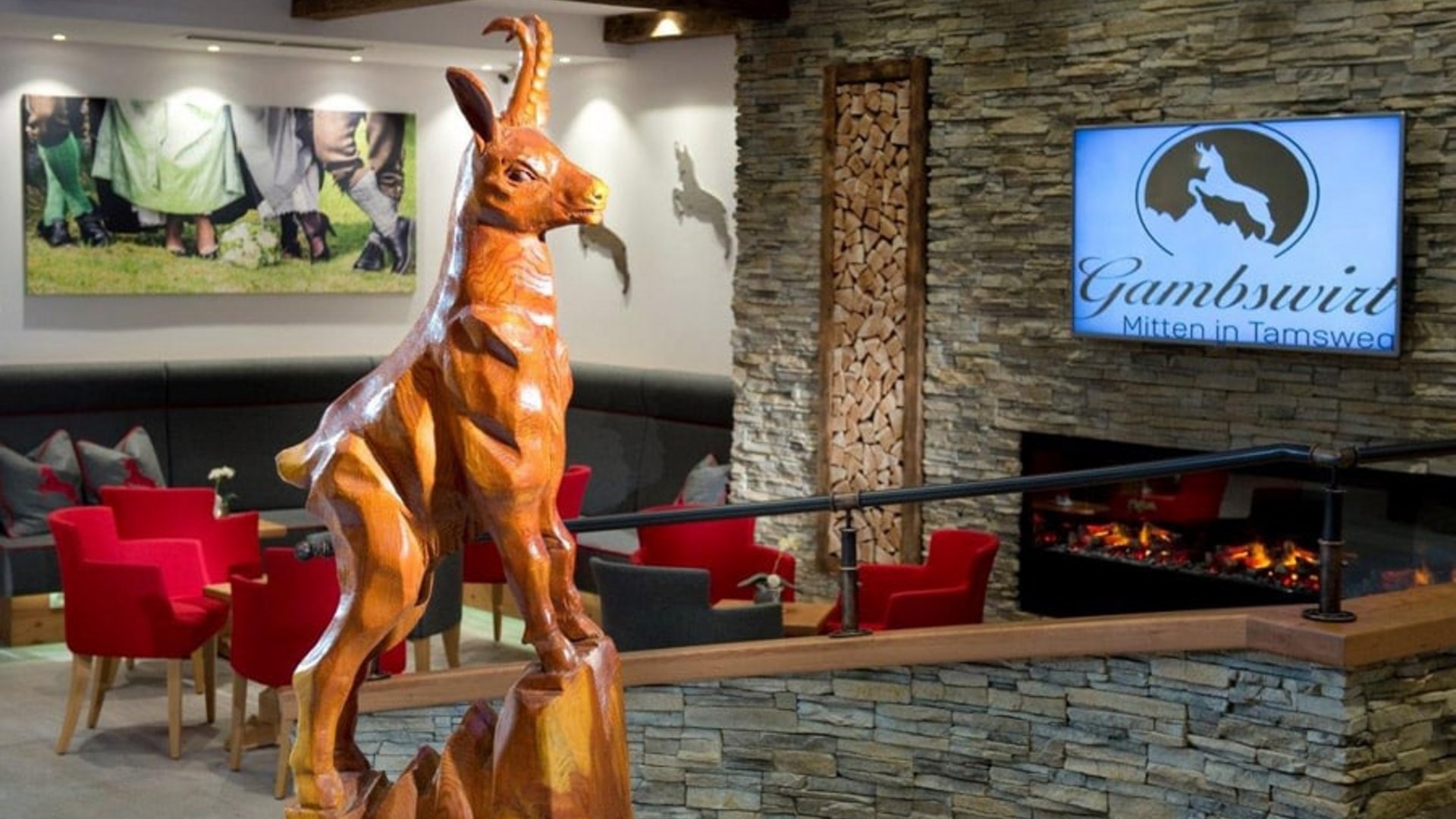 Wooden sculpture of a mountain animal in a cozy room with fireplace