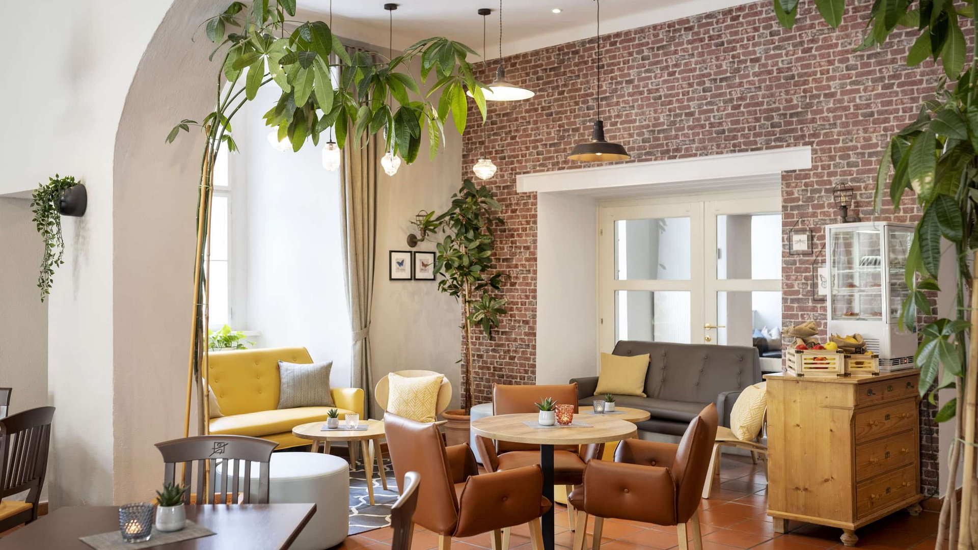 Cozy café interior with mixed seating and exposed brick wall