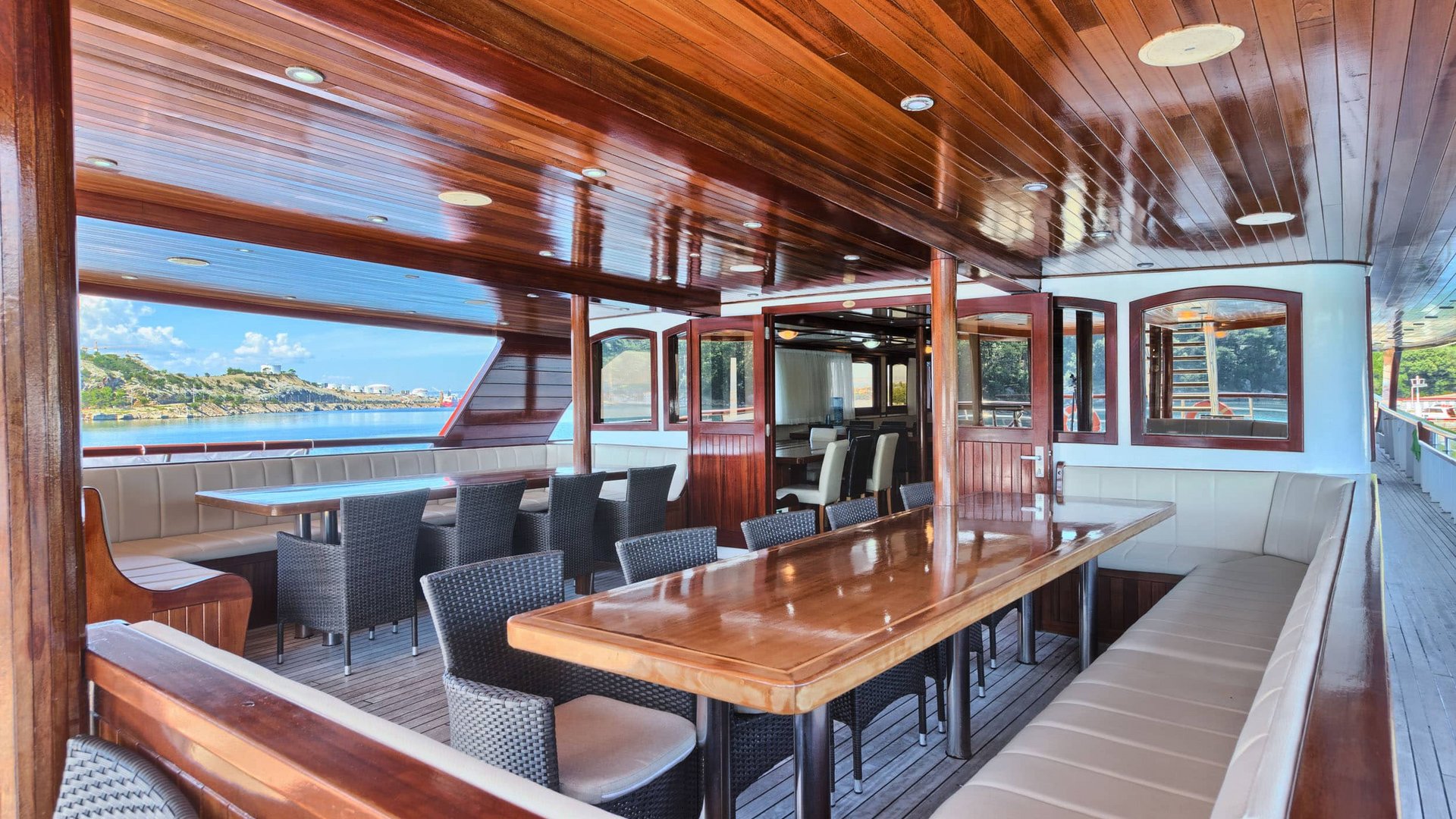 Dining area with wooden ceiling and tables on a boat