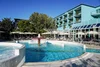 Collective enquiries © Emanuele Rambaldi Pool with fountain and umbrellas next to blue hotel building