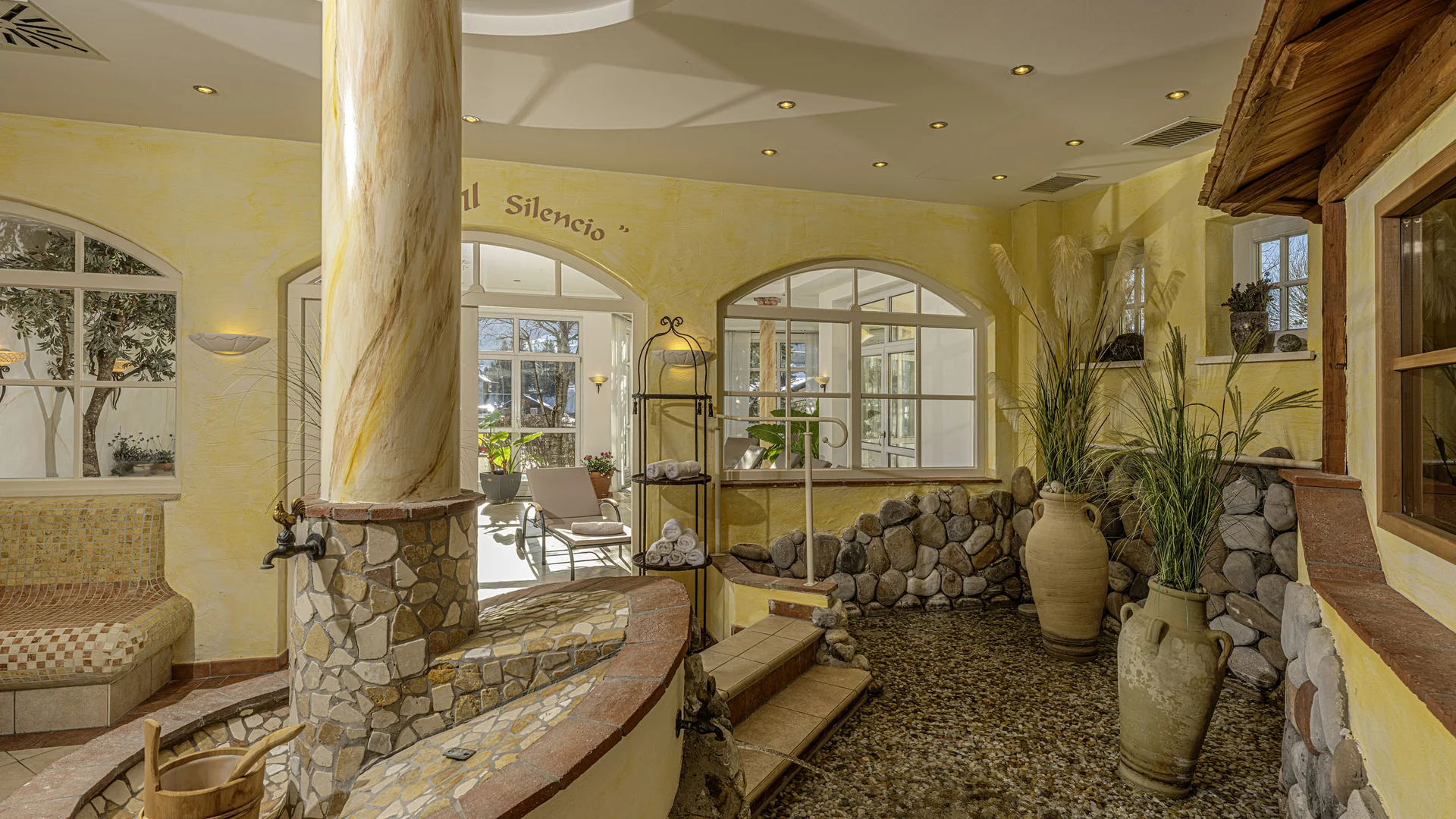 Indoor spa area with stone pools and decorative plants