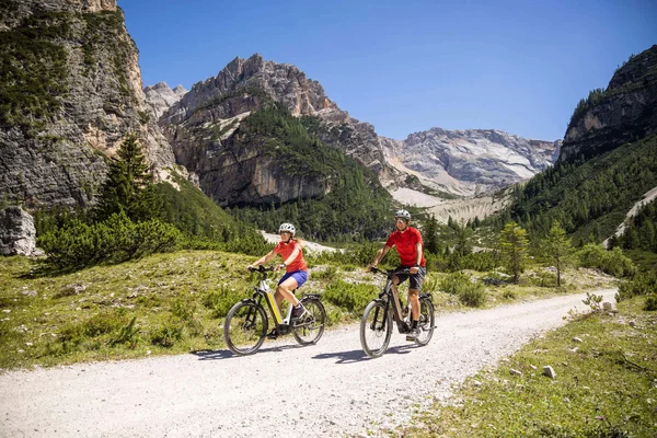Italy © Velontour Two cyclists riding on a mountain path on a sunny day