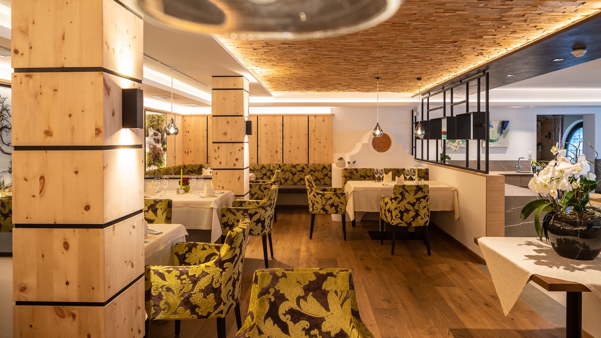 Elegant dining room with green patterned chairs and wooden accents
