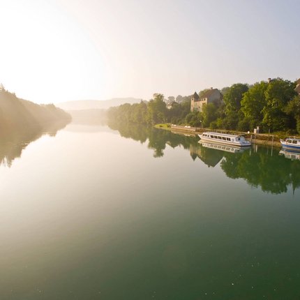 River with boats and town in morning light