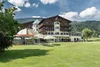 Collective enquiries © Alexander Maria Lohmann Hotel by golf course with green lawn and forested hills in the background