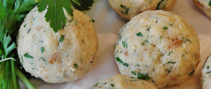 Fresh bread dumplings with parsley on parchment paper