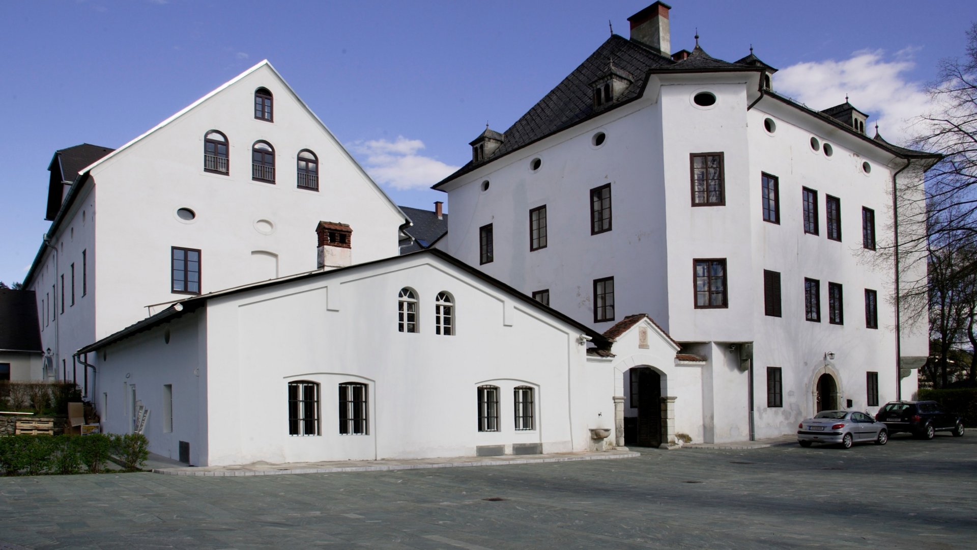 Large white historic building under clear blue sky