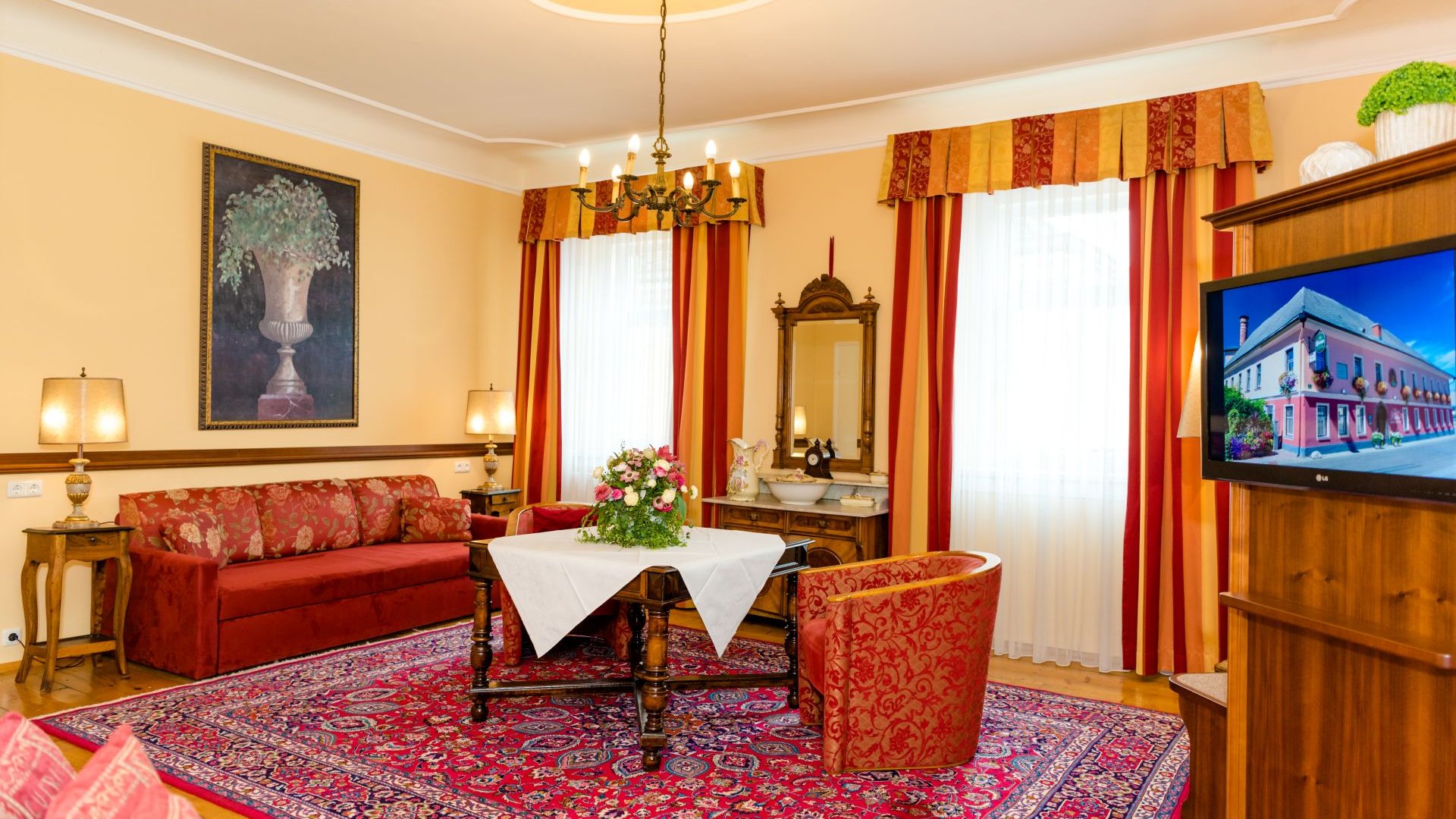 Cozy living room with antique furniture and red carpet