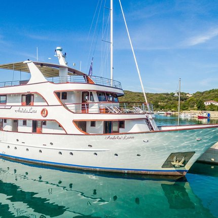 White ferry docked at harbor under blue sky