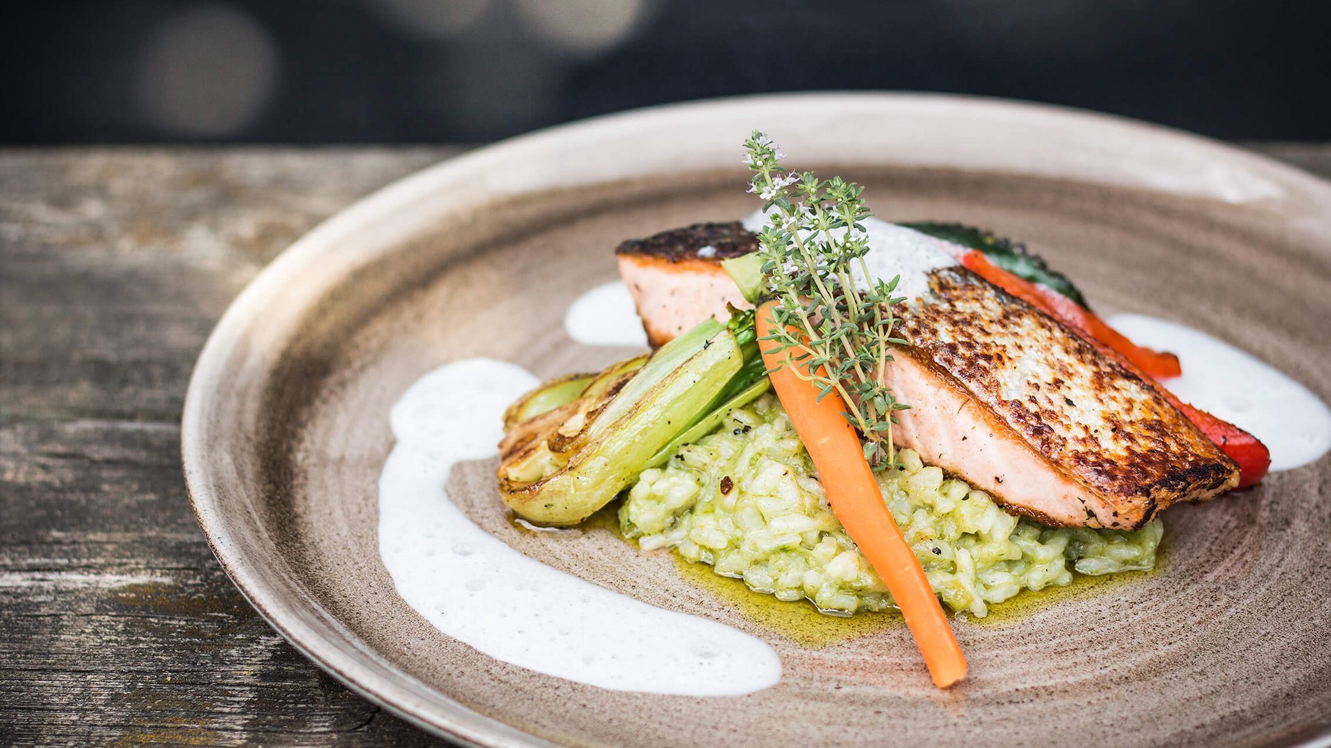 Grilled salmon fillet with vegetables and herbs served on rice