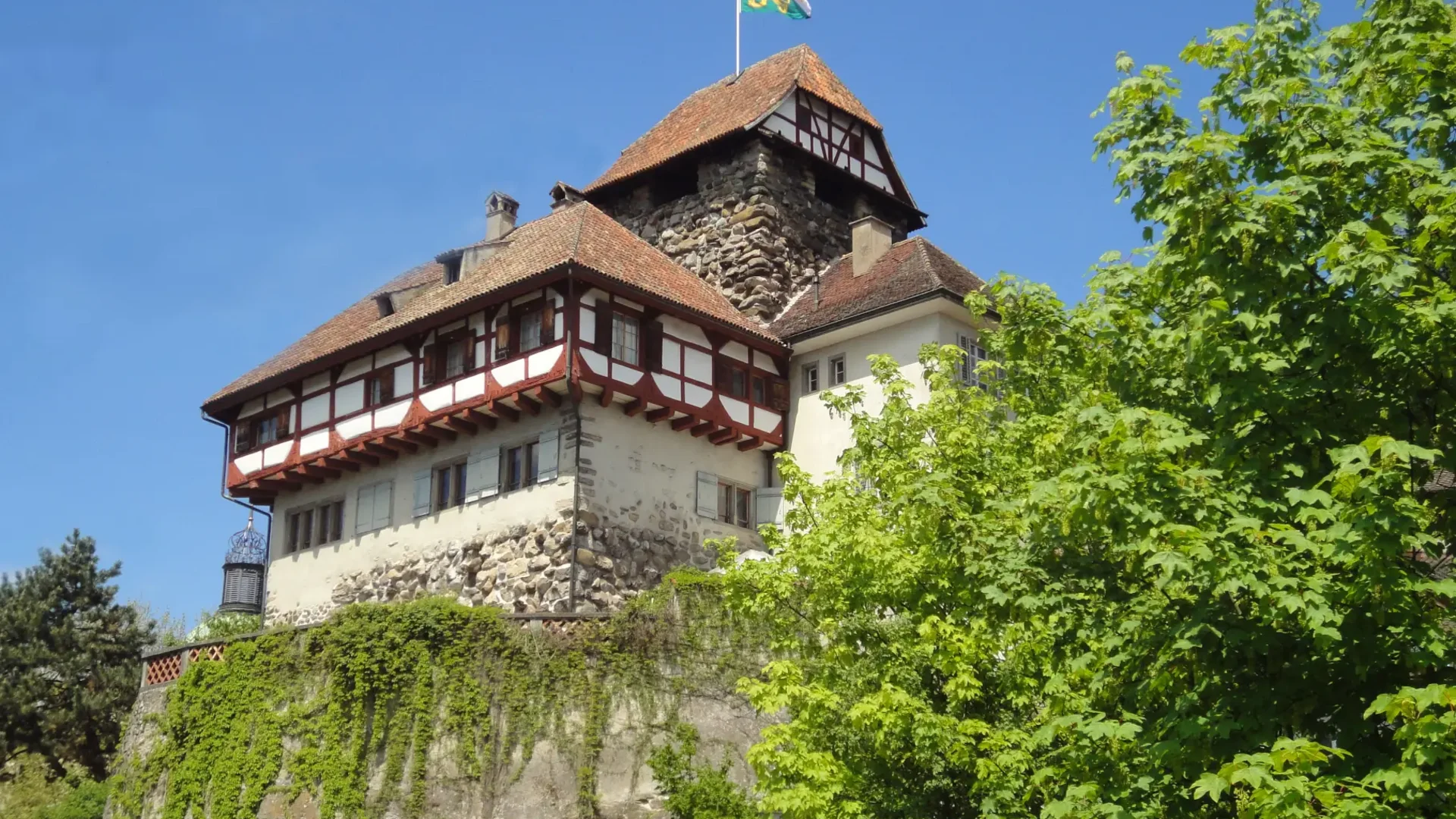 Tour detail Historic castle with wooden timber windows under blue sky