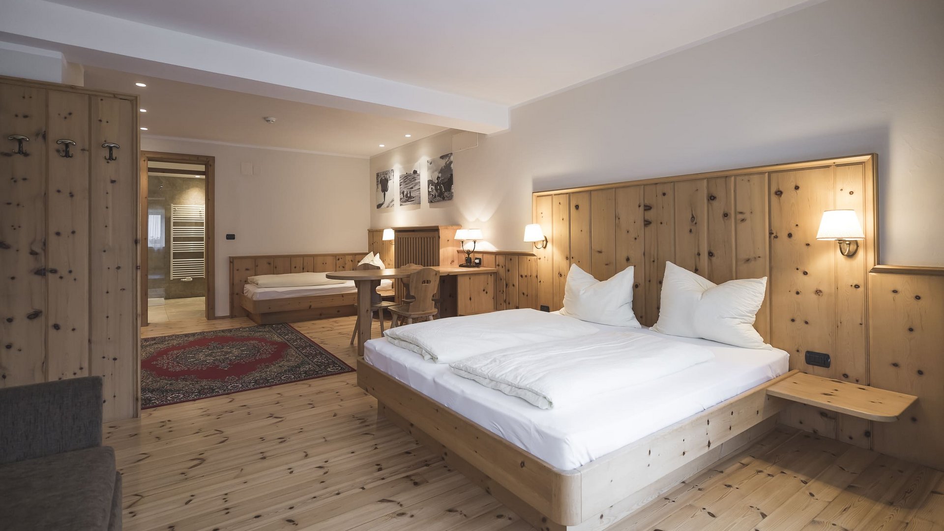 Cozy hotel room with two beds and wooden paneling