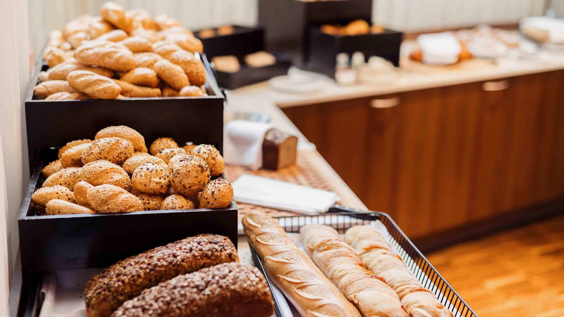 Various breads and rolls displayed on a buffet