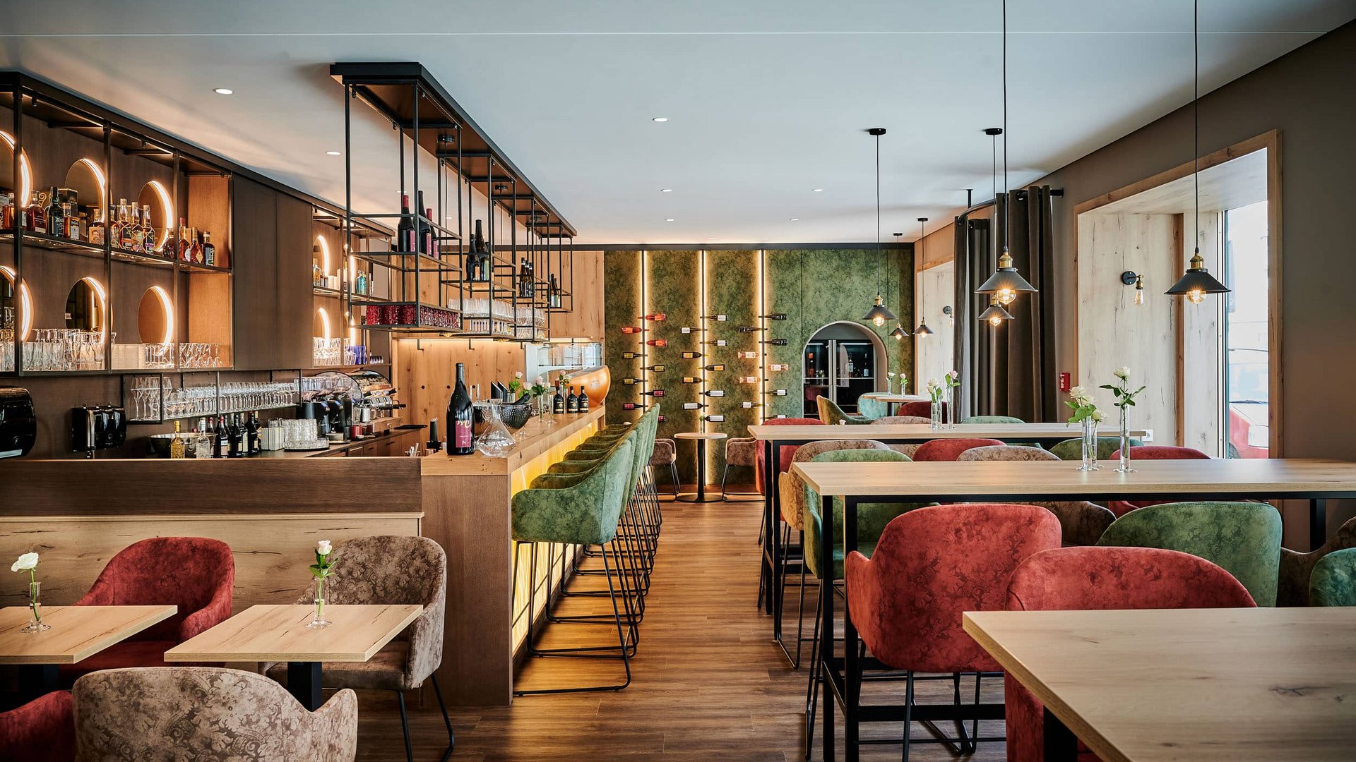 Modern bar interior with colorful chairs and stylish lighting