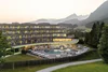 Collective enquiries © Alex Gretter Modern hotel with pool against mountain backdrop and forests