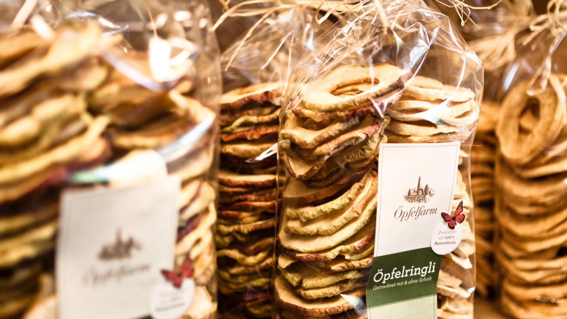 Bags of dried apple rings on wooden shelf