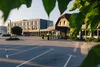 Collective enquiries Empty parking lot in front of modern hotel building in daylight