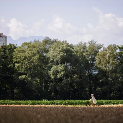 Twee fietsers op een pad met bos en kasteel op de achtergrond