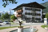 Collective enquiries © Gasthof Zur Post Traditional inn with fountain and statue in front of alpine mountain backdrop