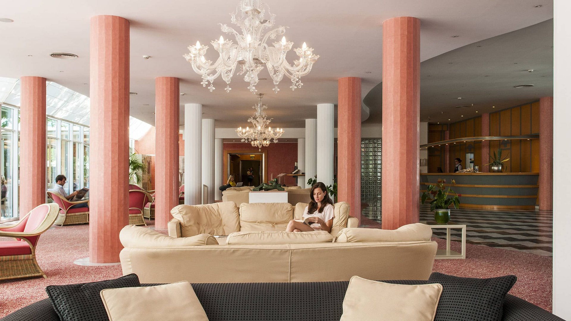 Hotel lobby with beige sofas and pink columns