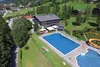 Collective enquiries © Lakenmacher Hotel GmbH Outdoor pool with water slide next to hotel in green mountain landscape