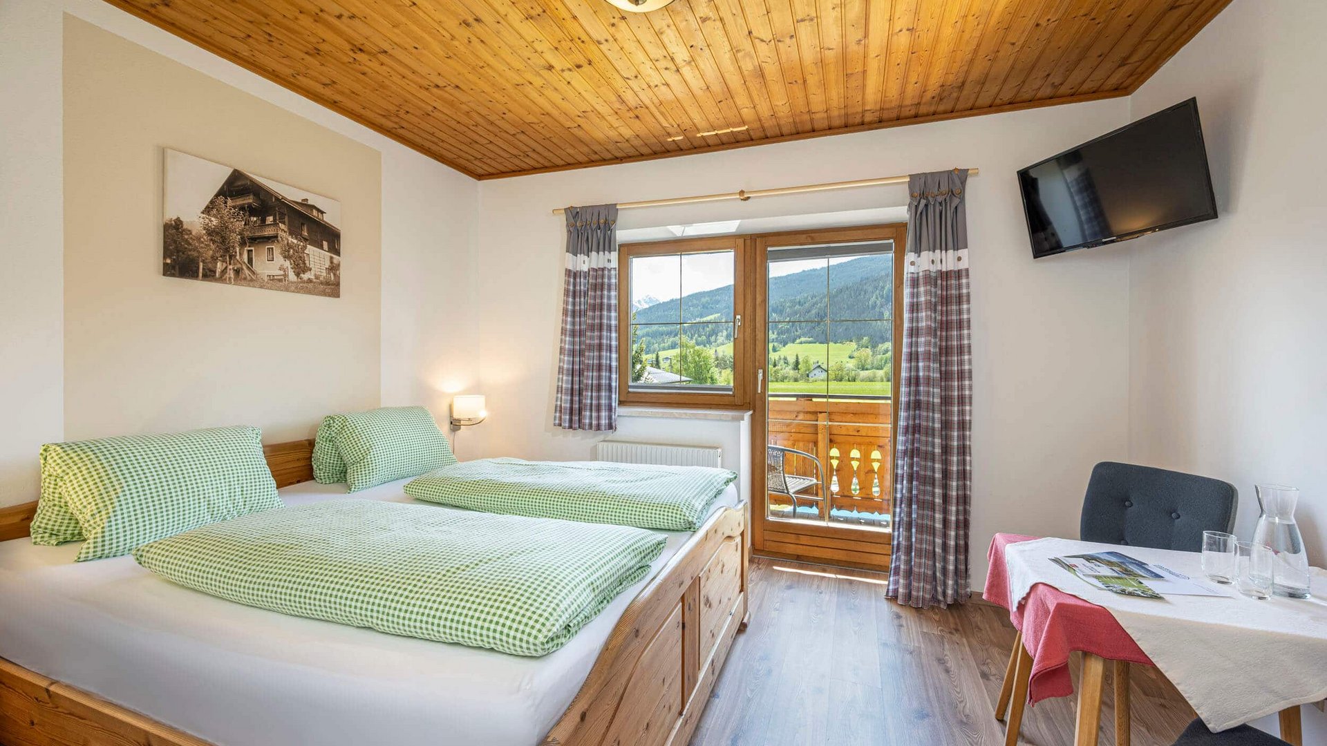 Cozy guest room with wooden furniture and mountain view