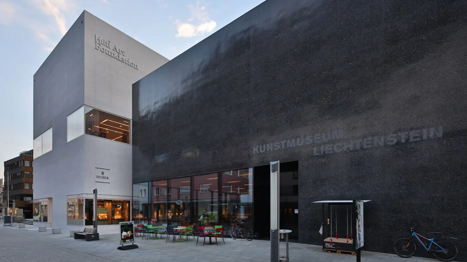 Modern Liechtenstein art museum with outdoor seating in the city