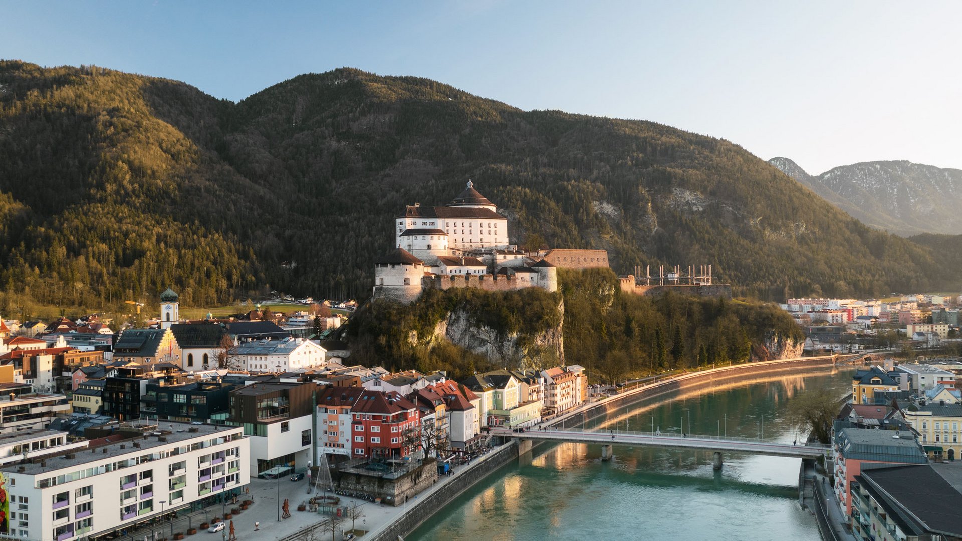 View of a castle on a cliff with town and river in the foreground