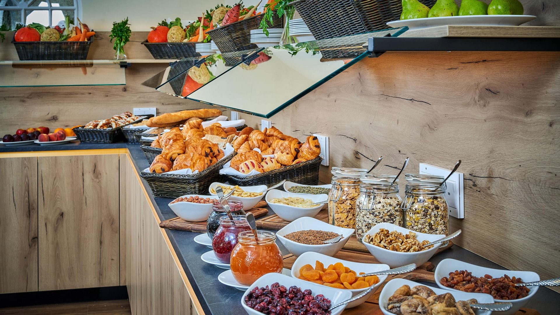Buffet with fresh pastries, jams, and dried fruits