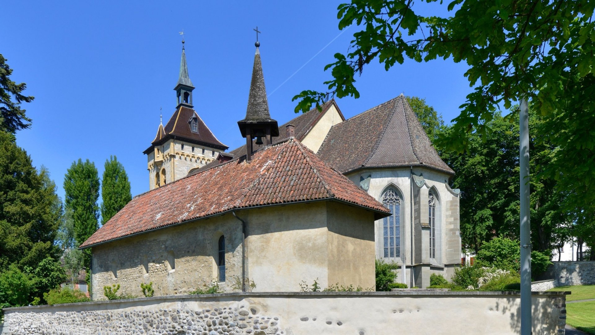 Historic church with towers and gables under clear blue sky