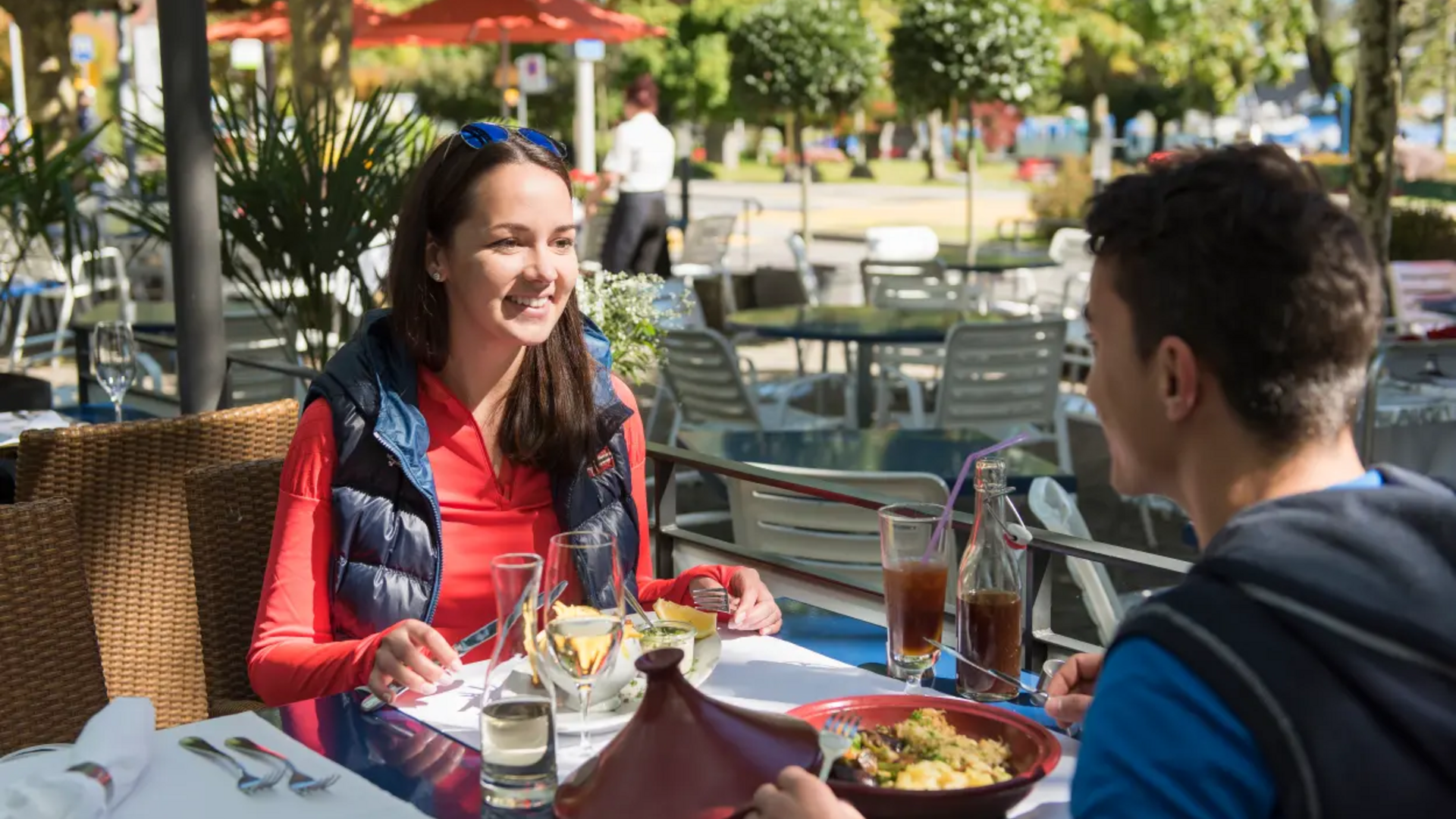 Two people dining outdoors at a restaurant in daylight