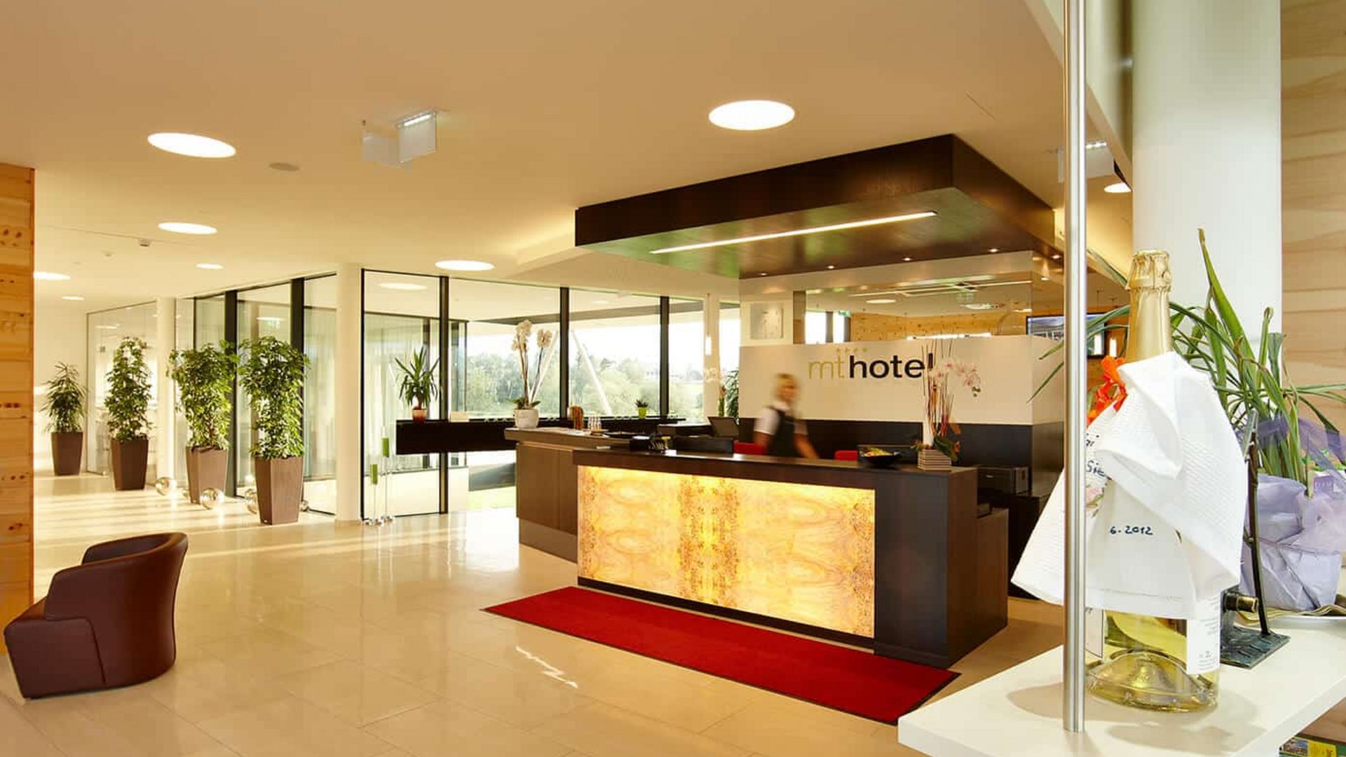 Bright hotel lobby with reception desk and information brochures
