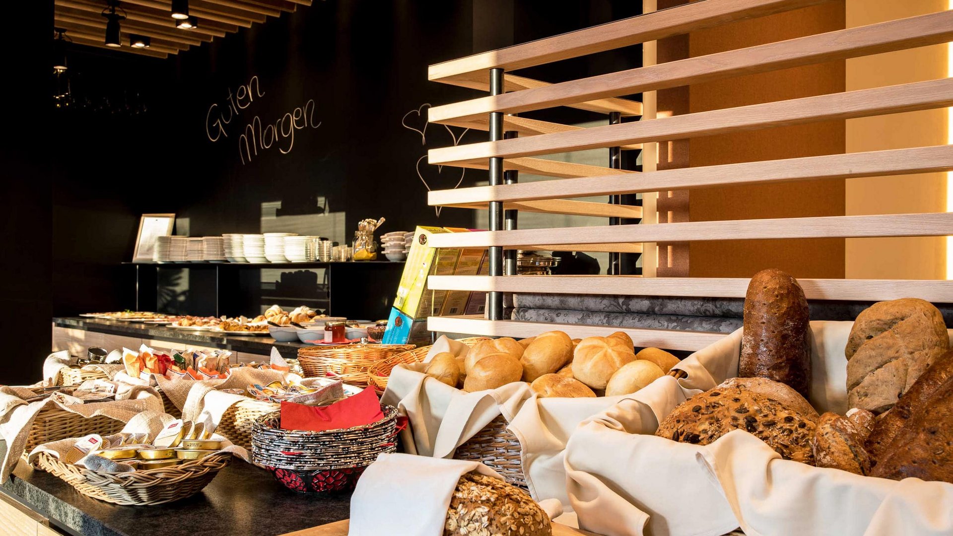 Breakfast buffet with assorted breads and rolls in baskets