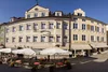 Collective enquiries Historic building with outdoor café seating on sunny street