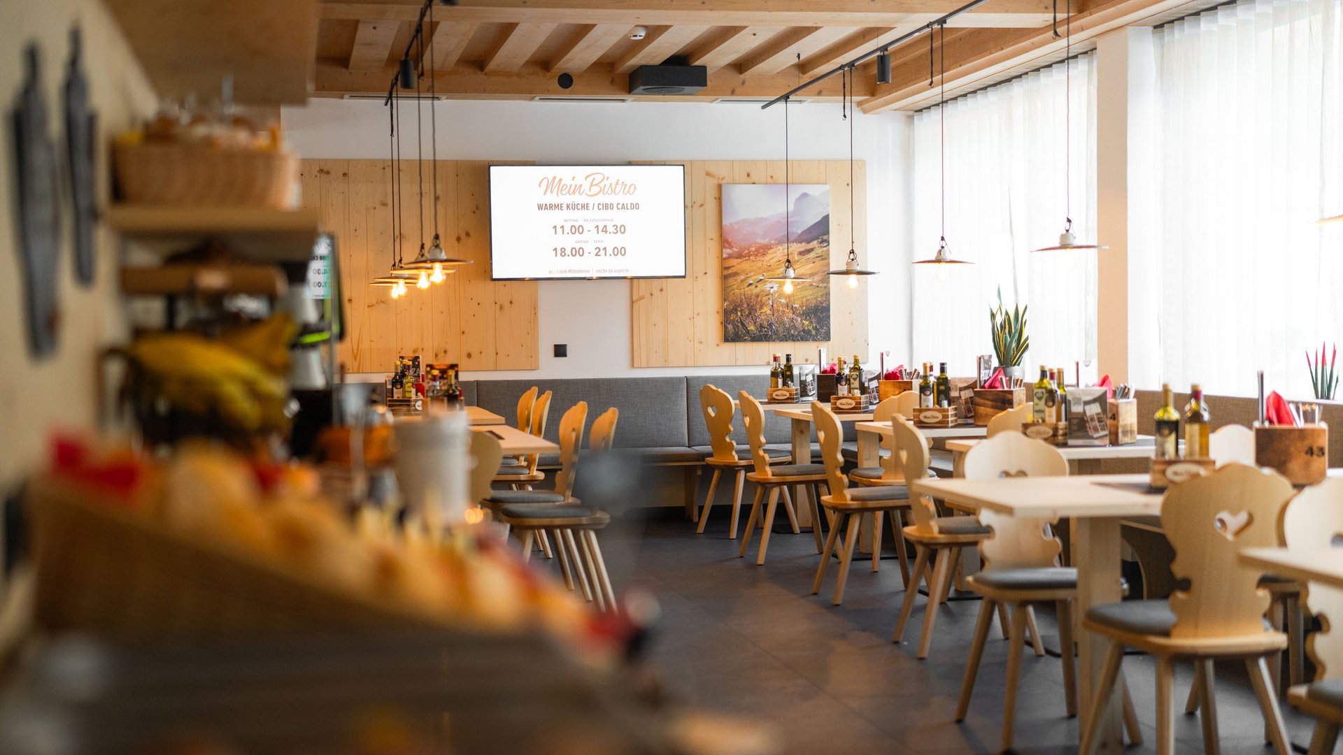 Bright bistro with wooden furniture and hanging lights