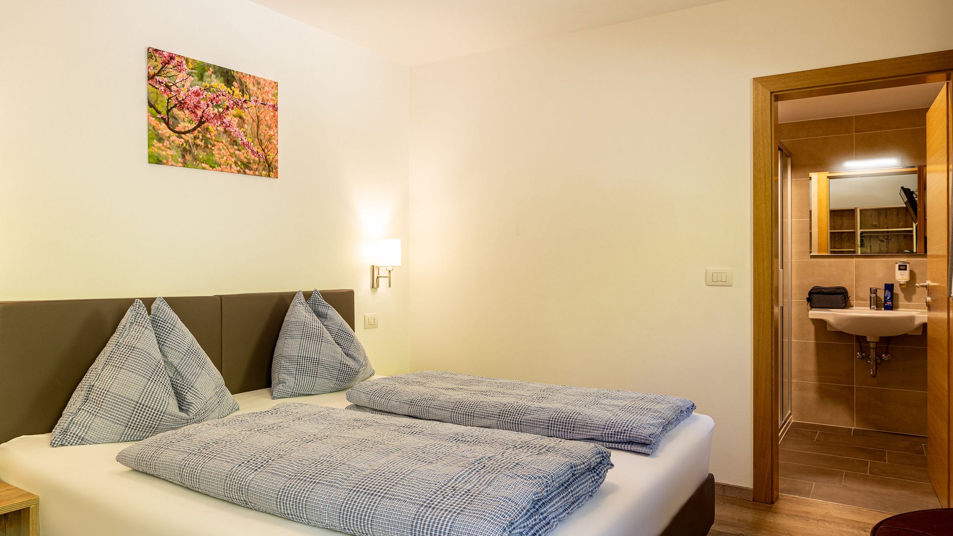 Small cozy bedroom with double bed and adjoining bathroom