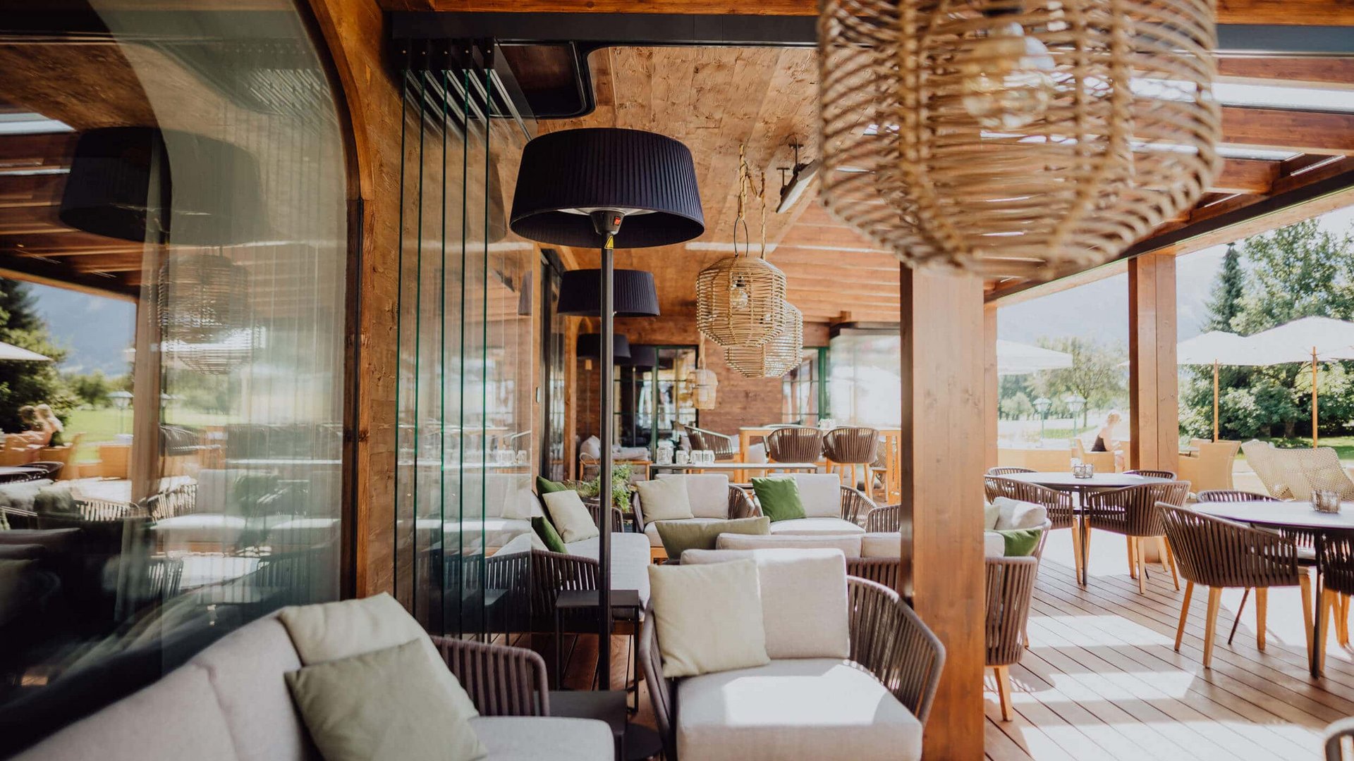 Bright lounge area with wooden furniture and garden view