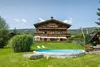 Collective enquiries © Lorenz Masser Fotografie House with balcony, garden, pool and lounge chairs near forested mountain