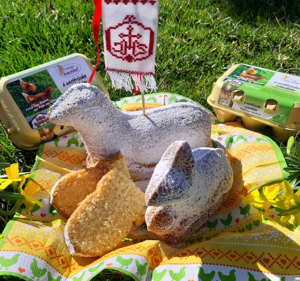 Easter treats shaped like lamb and rabbit with eggs and spring flowers