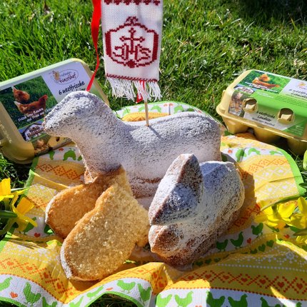 Easter treats shaped like lamb and rabbit with eggs and spring flowers