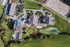 Collective enquiries © Gut Weissenhof Aerial view of a large building complex with pond and landscaped gardens
