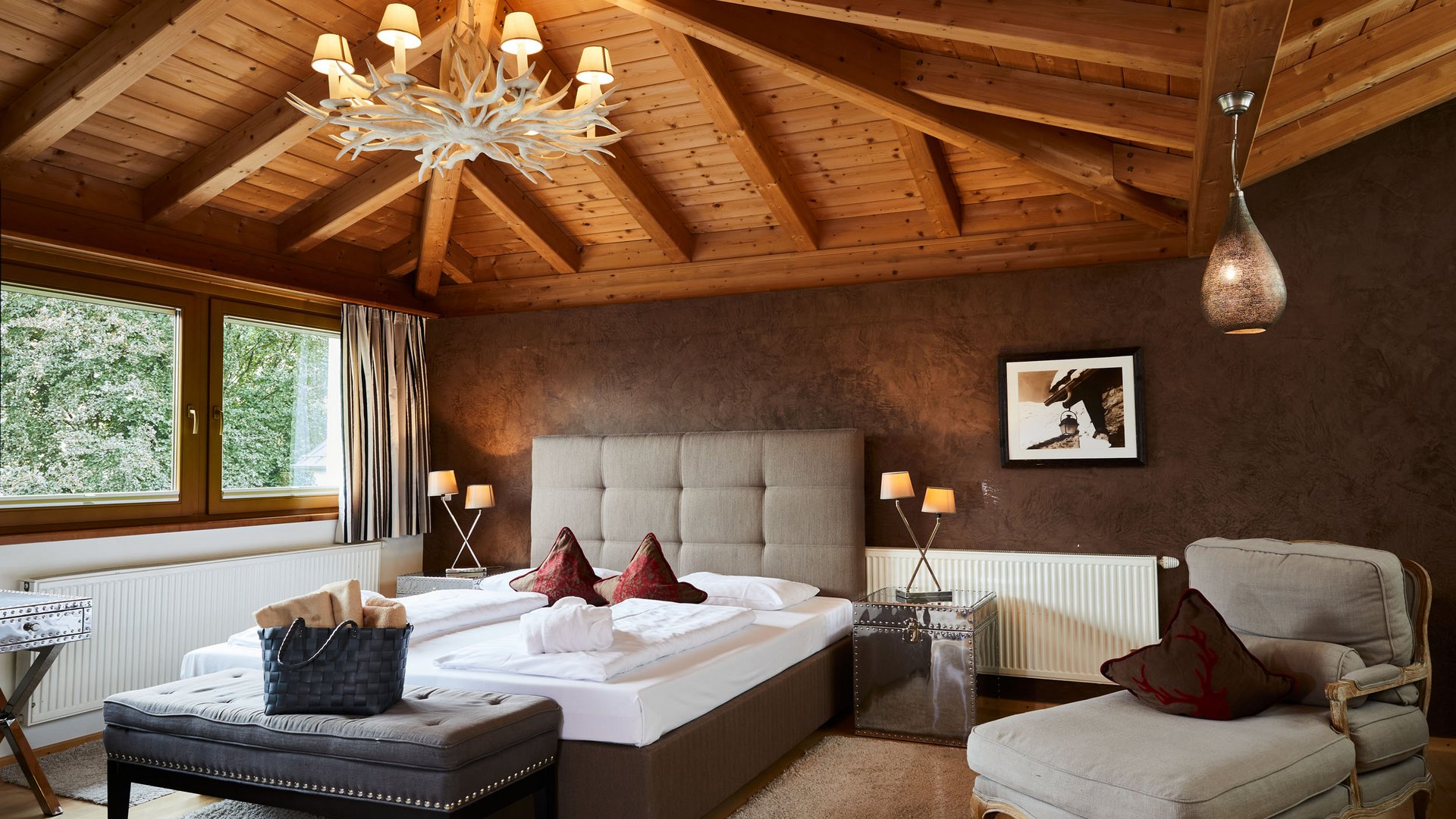 Rustic bedroom with wooden ceiling beams and cozy bed