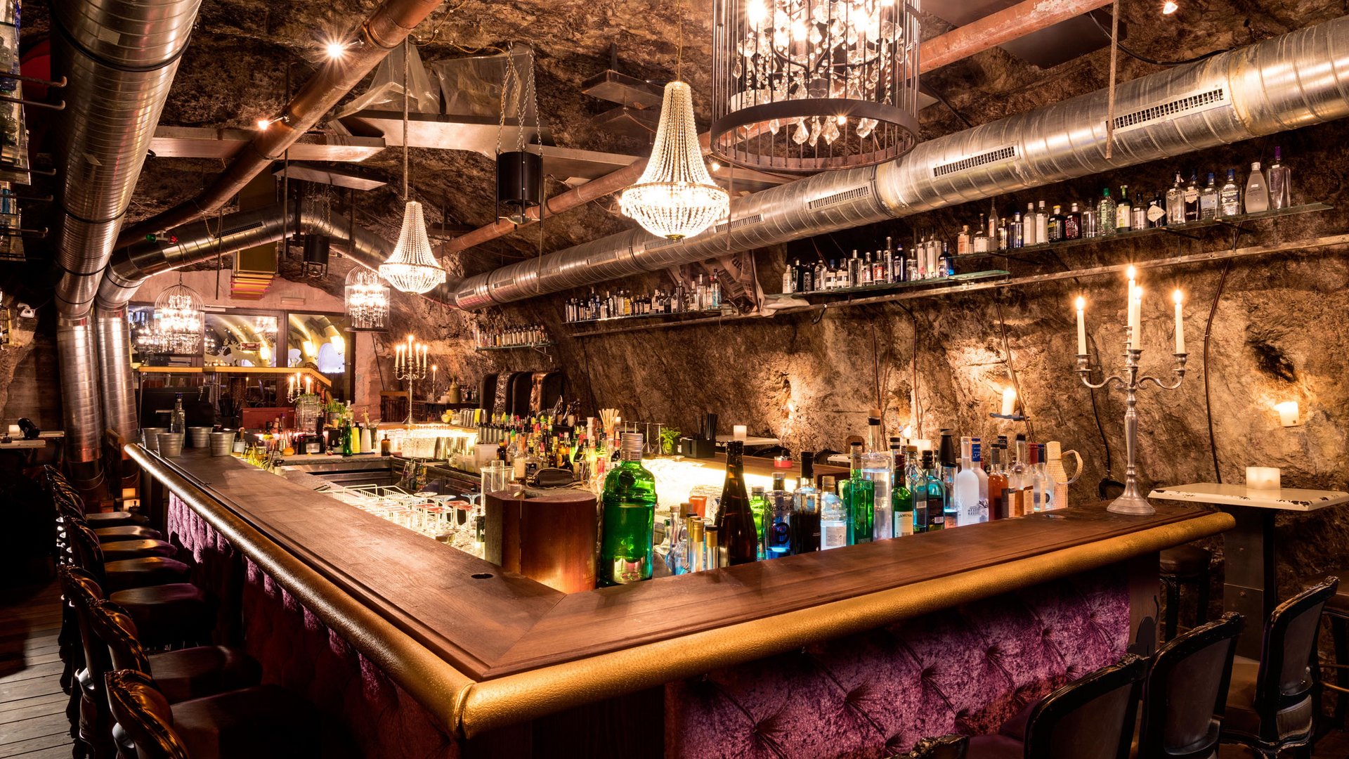 Stylish bar in an underground vaulted room with chandeliers