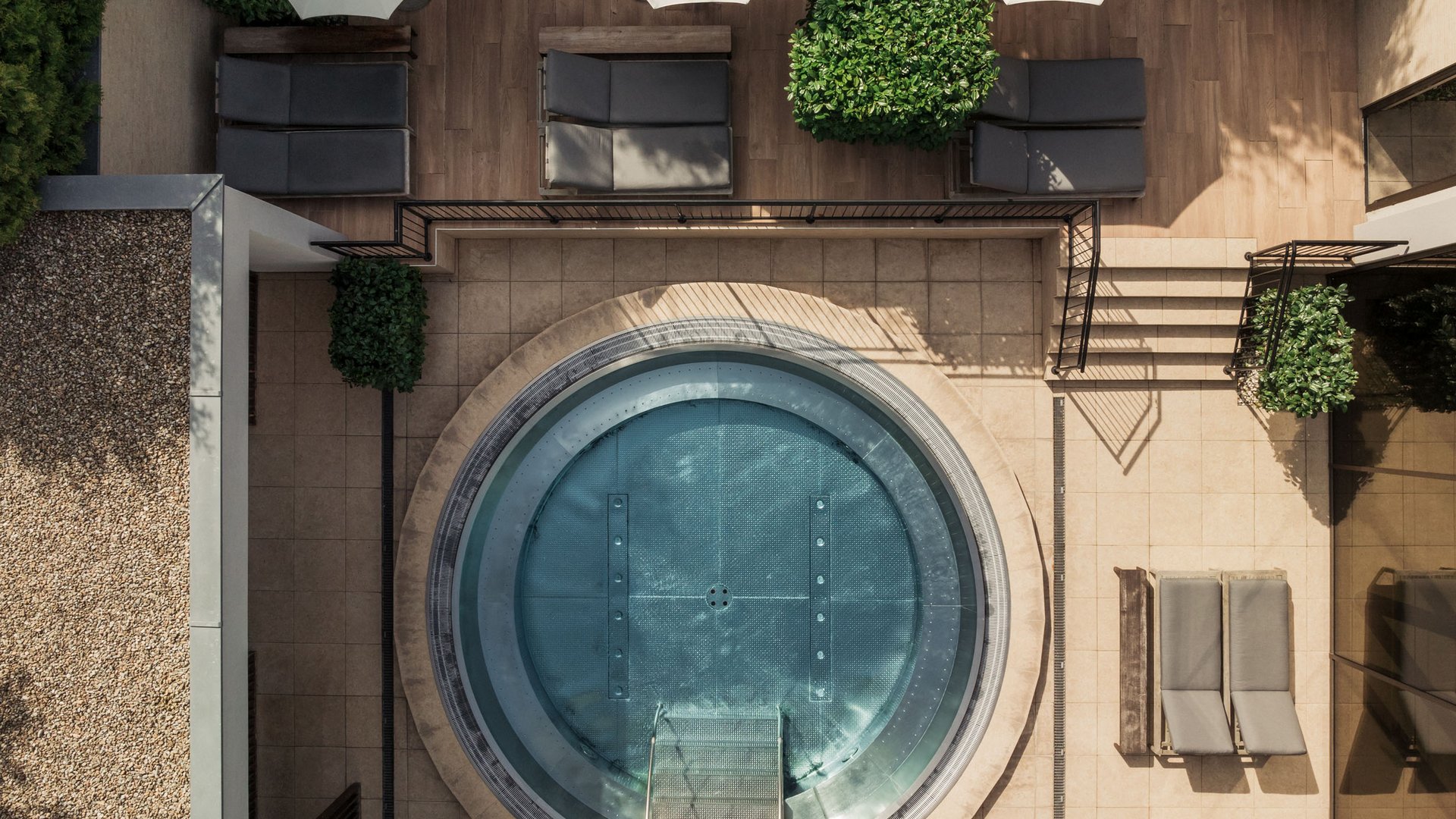 Top view of jacuzzi with umbrellas and lounge chairs