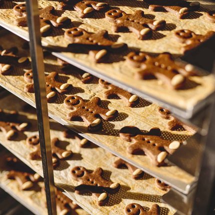 Baking trays with gingerbread men in the oven