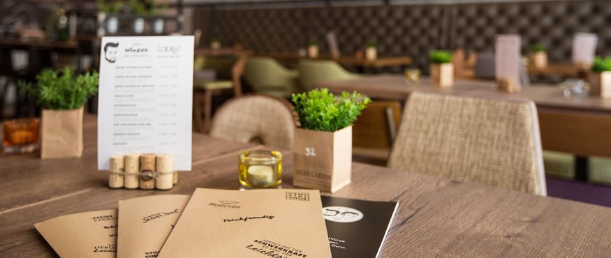 Menus on a wooden table in a cozy restaurant