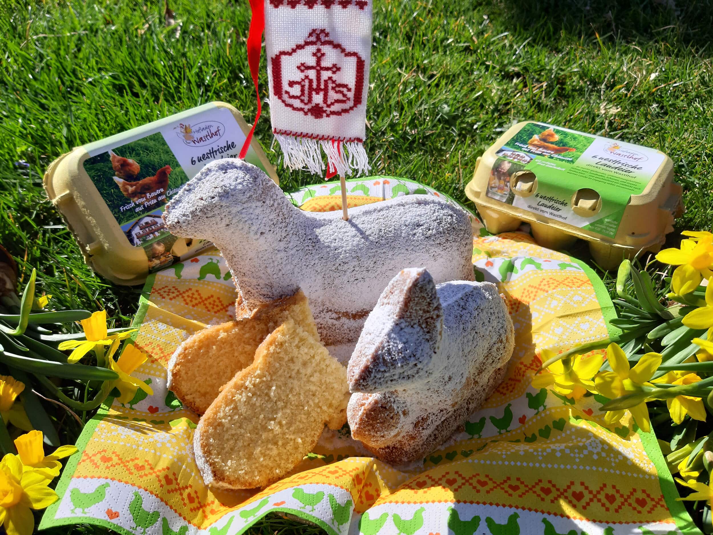 Easter treats shaped like lamb and rabbit with eggs and spring flowers