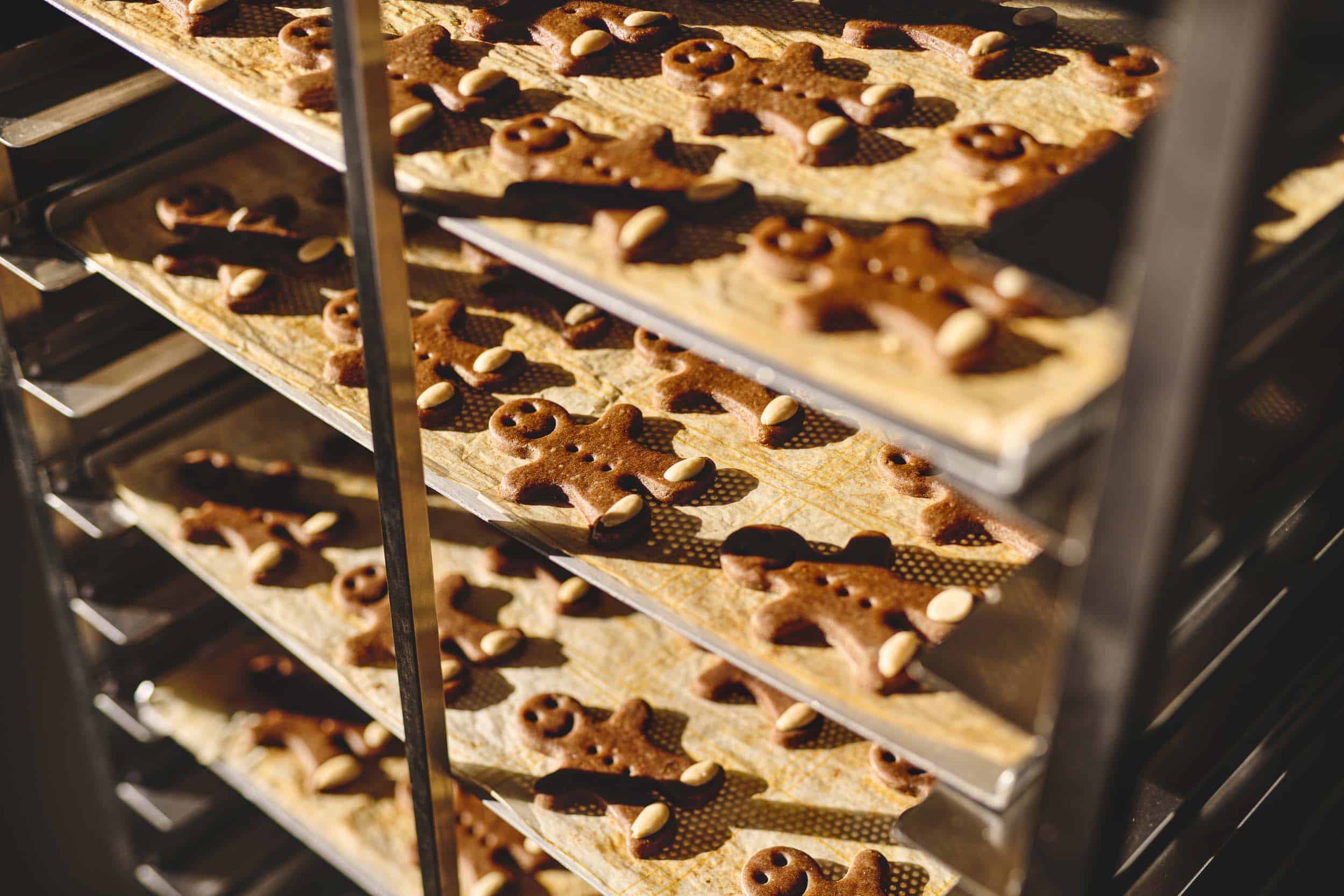 Baking trays with gingerbread men in the oven