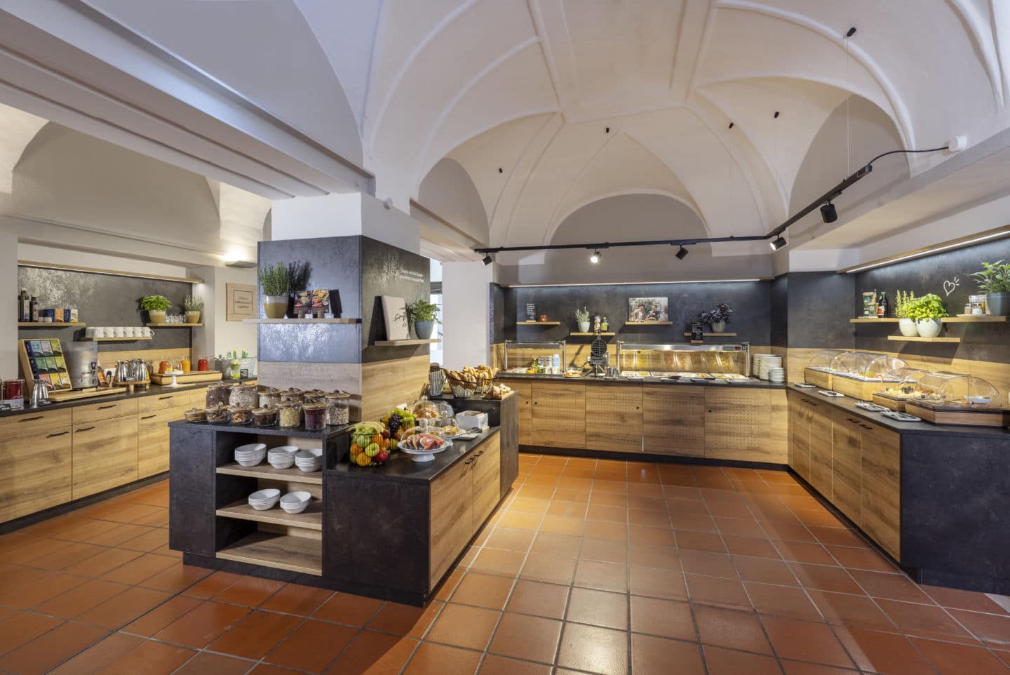 Modern buffet with breakfast and snacks in a room with vaulted ceilings